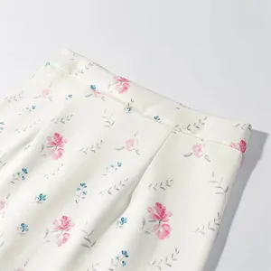 Floral print skirt detail close-up shot, elegant style, smooth premium fabric texture.