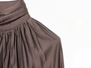 Close-up detail of women's long sleeve stand collar draped blouse, soft fabric texture showcase.