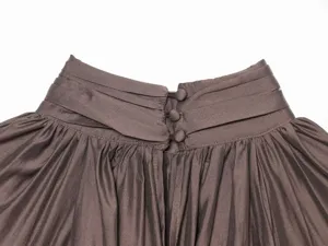 Close-up detail of women's elegant pleated high collar blouse with back buttons.