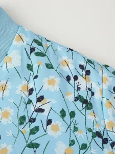 Women's light blue floral printed cotton padded jacket shoulder and collar detail view.