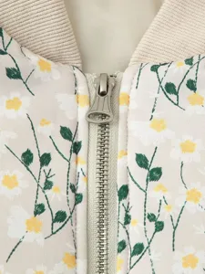 Close-up detail view of women floral print padded jacket featuring zipper and collar.