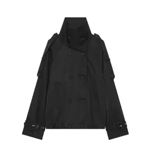Close-up detail of black short trench coat with high funnel neck and double-breasted design.