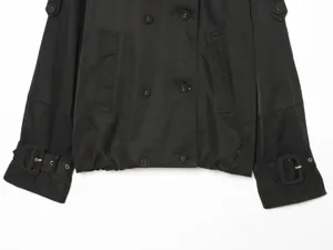 Black short trench coat detail, double-breasted design, adjustable cuffs, stylish outerwear.