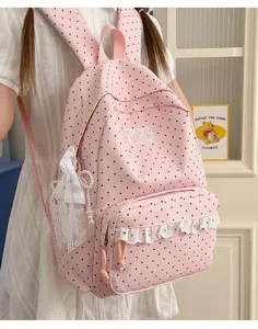 Pink polka dot backpack with lace trim, sweet style school bag for daily use and travel.