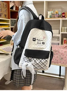 Detailed view of the cute polka dot backpack with plaid pocket and elegant bow decoration.