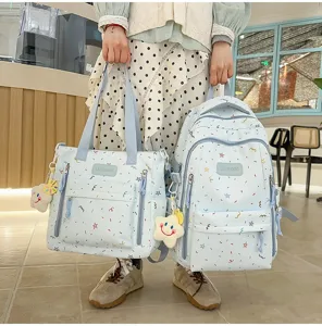 Light blue student school backpack and tote bag set with cute colorful doodle star prints for girls.