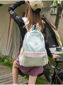 Outdoor casual canvas backpack detail, stylish color-block design with cute star pendant.
