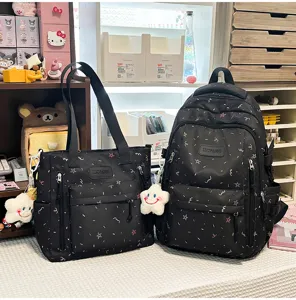 Detailed shot of black casual school backpack and tote bag set with cute colorful star prints.