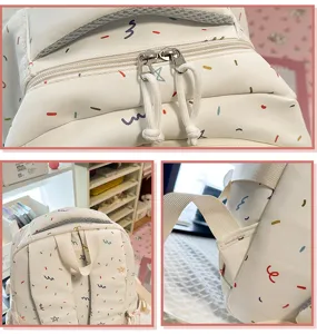 Backpack detail featuring durable dual zippers, adjustable straps and cute star print fabric.