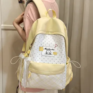 Gentle style yellow polka dot school backpack for women, cute casual campus daily daypack.