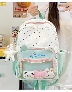 Detail shot of the cute polka dot backpack featuring transparent front pocket, plush toys.