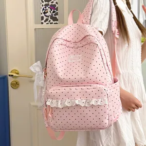 Pink polka dot backpack with white lace trim, cute college style school bag for girls.