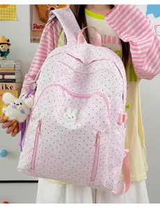Cute pink polka dot school backpack detail with bunny patch and pendant for students daily use.