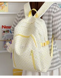 Cute yellow polka dot school backpack with rabbit design, large capacity for students.