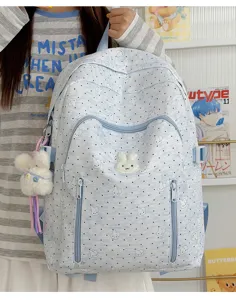 Detailed view of the cute light blue bunny print backpack with fluffy pendant and pockets.