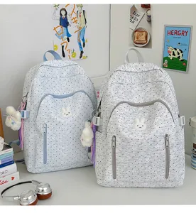 Cute polka dot cartoon school backpack for teen girls, large capacity casual daypack with bunny charm.