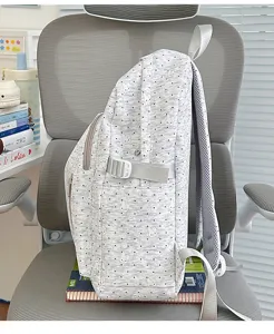 Detailed side view of the cute grey rabbit print backpack showing fabric and pocket.