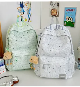 Chic star printed school backpack for teen girls, cute casual daypack with cloud pendant.