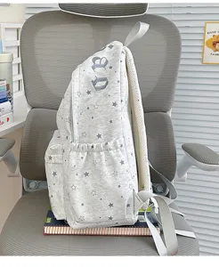 Light grey star printed casual backpack detail view with side pocket and shoulder strap.