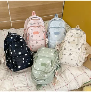 Detail view of colorful printed backpacks showing different color options and storage features.