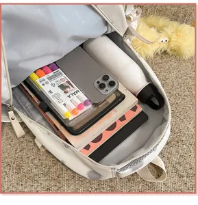 Detailed interior view of the polka dot backpack showing spacious capacity with daily items.
