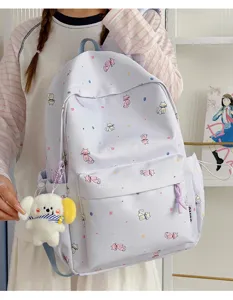 Korean style cute cat print canvas backpack with plush dog pendant, casual student schoolbag.