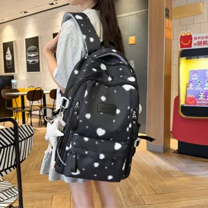 Casual black backpack for women with white star print, stylish daily school bag for students.