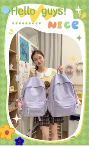 Lightweight solid color school backpack for women, casual cute daily bookbag with cute charm.