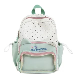 Cute polka dot backpack with cat ears and transparent pocket for stylish school students.