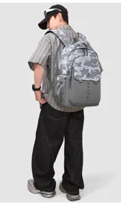 Detailed view of large capacity grey camo backpack featuring durable oxford fabric and multiple pockets.