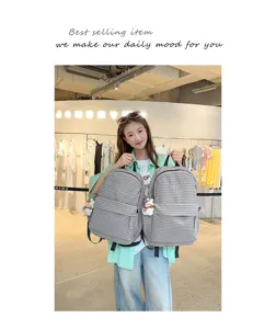 Korean style casual striped backpack detail view featuring cute doll pendant and storage.