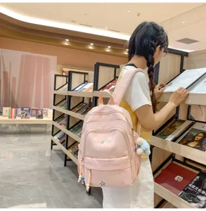 Pink casual backpack for women and girls, large capacity travel school bag with cute pendant.