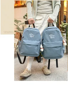 Detailed view of the casual blue plaid backpack, stylish student schoolbag with pockets.