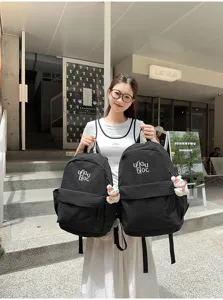 Korean style casual black plaid backpack for women, lightweight school bag with pendant and pockets.