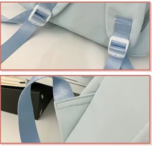 Close-up detail of light blue backpack shoulder straps, adjustable buckles, and neat stitching.