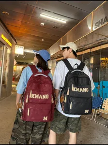Unisex large capacity casual student backpack with retro letters for school and daily travel use.