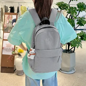 Grey striped casual backpack for women, stylish Harajuku style school bag worn on model back.