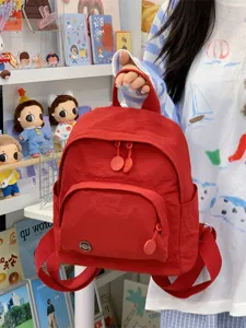 Mini red backpack for women, casual cute small shoulder bag for daily travel and shopping.