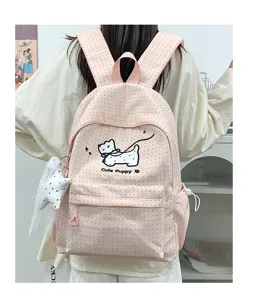 Pink polka dot backpack detail showing cute puppy print, front pocket and sweet student style.