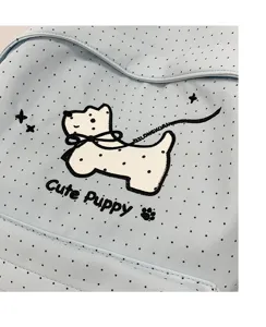 Close-up detail of cute blue polka dot backpack featuring lovely puppy embroidery design.