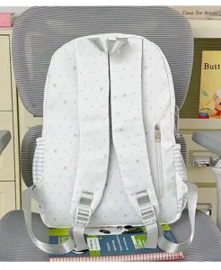 White polka dot backpack with star patterns, durable student school bag with multiple storage pockets.
