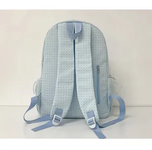 Light blue polka dot backpack detail showing adjustable shoulder straps and back design.