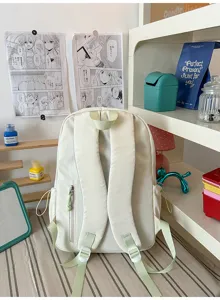Minimalist solid color backpack detail view, casual school bag with adjustable straps and side pockets.