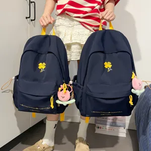 Casual navy blue backpack with yellow straps and clover embroidery for daily school use.