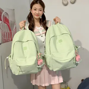 Light green canvas school backpack casual student daypack with cute clover embroidery.