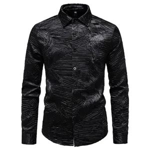 Close-up detail of black textured pleated long sleeve shirt fabric and lapel collar design.