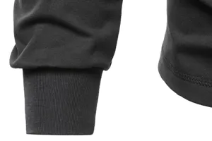 Detail view of mens long sleeve t shirt cuff, black cotton stretch ribbed fabric, stylish top.