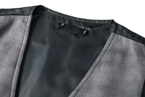 Men's vintage suede plaid waistcoat detail showcasing stylish design and inner label.