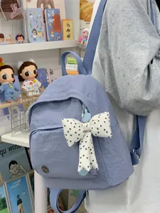 Minimalist mini backpack for women, cute casual campus style school bag with polka dot bow.