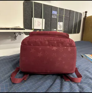 Burgundy casual backpack with star pattern, large capacity travel school bag for daily use.